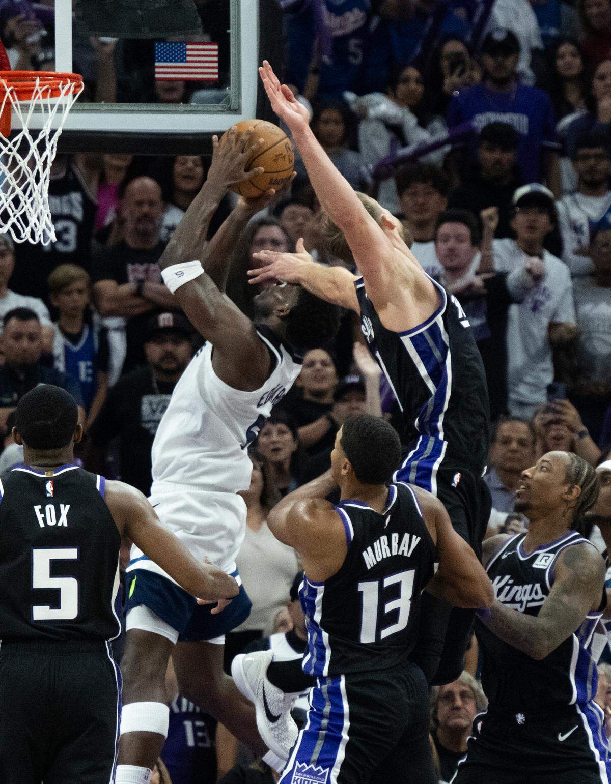 Sacramento Kings center Domantas Sabonis (11) fouls Minnesota Timberwolves guard Anthony Edwards (5) in the final minute during the season opener at Golden 1 Center on Thursday, Oct. 24, 2024.