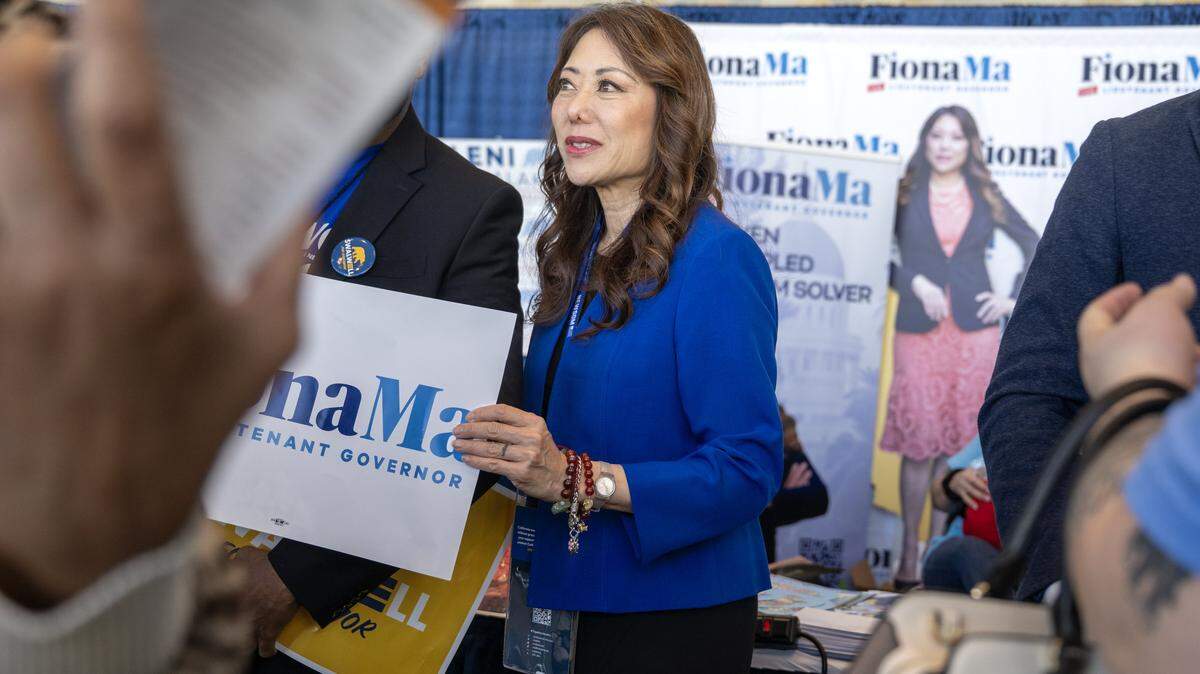 Fiona Ma, a candidate for lieutenant governor, holds a campaign sign at the California Democratic Convention in San Francisco on Saturday, Feb. 21, 2026.