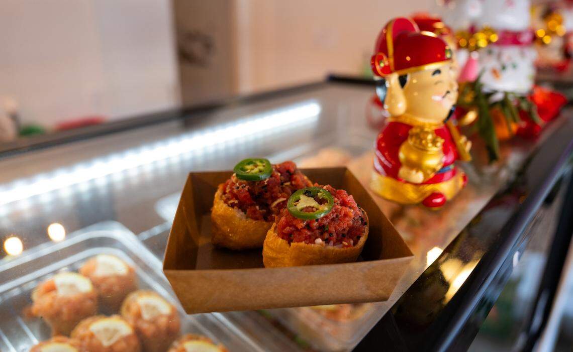 The menu at Rice Theory on Freeport Boulevard in Sacramento features a number of inari, race wrapped in fried tofu pouches, including this version topped with&nbsp;spicy ahi tuna.