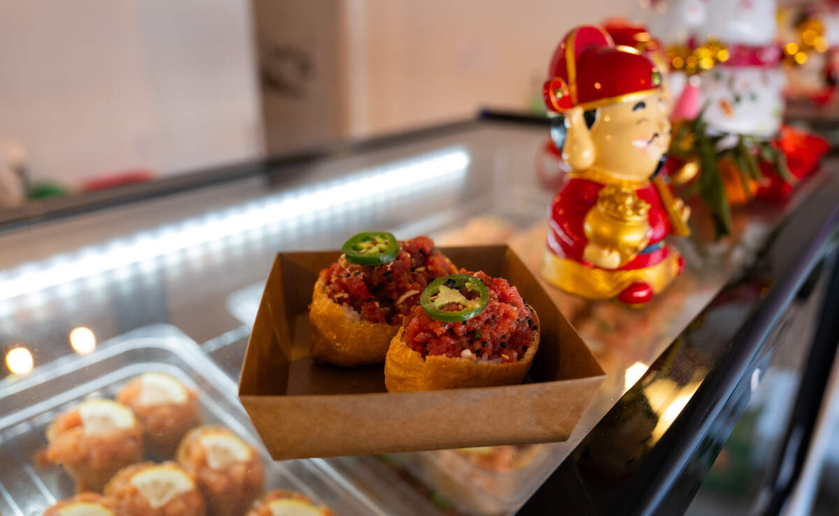 The menu at Rice Theory on Freeport Boulevard in Sacramento features a number of inari, race wrapped in fried tofu pouches, including this version topped with&nbsp;spicy ahi tuna.
