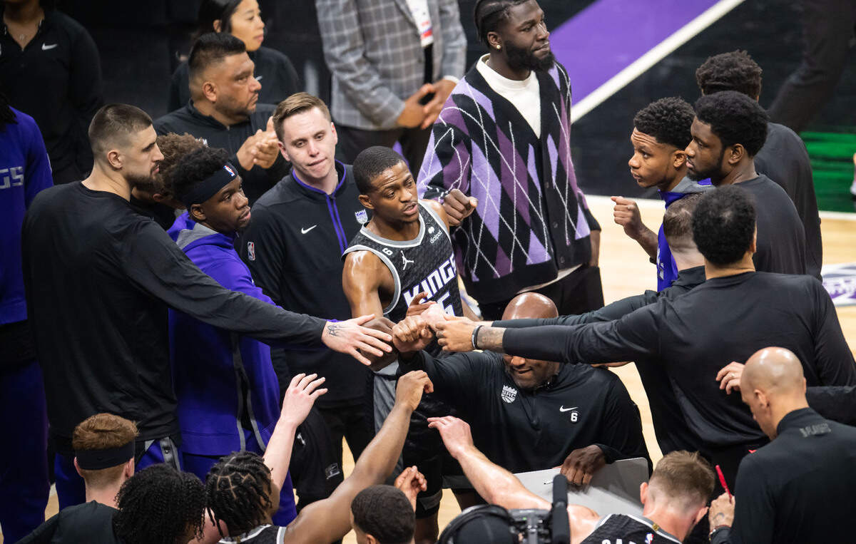 Sacramento Kings guard De’Aaron Fox (5), center, puts his hand in at the end of a timeout during the first half against the Golden State Warriors during the first half of Game 1 of the first-round NBA basketball playoff series at Golden 1 Center on Saturday, April 15, 2023.
