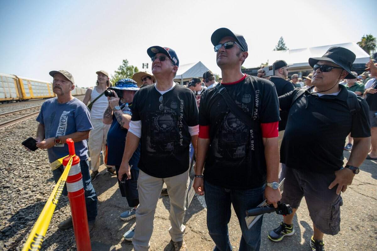 Train enthusiasts Mike Lester and his son Jeremy, center, have their first look at Union Pacific’s Big Boy No. 4014 steam locomotive on Friday in Roseville. “I grew up with this with my father being a rail fan, and to see Big Boy for the first time, it’s mind blowing and historic,” he said.