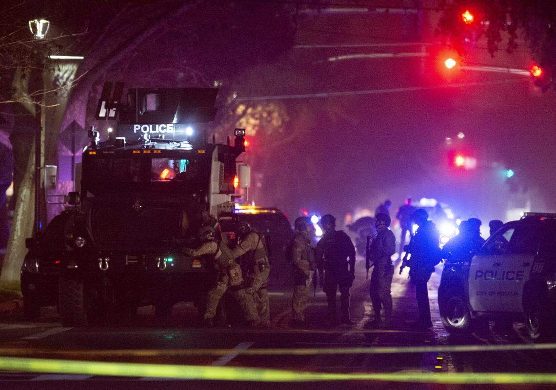 Davis Police prepare to enter the premises where they believed the suspect who shot and killed a Davis Police officer earlier in the evening was hiding out near 5th and D streets in Davis on January 10, 2019.