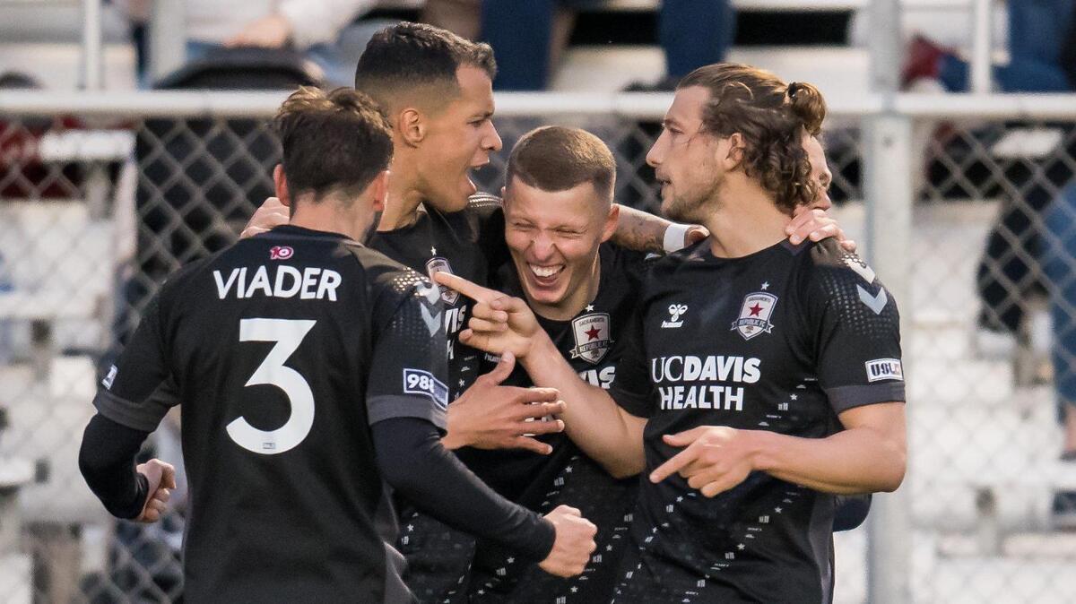 Sacramento Republic FC forward Russell Cicerone (11), right, and midfielder Luis Felipe (96) surround laughing defender Jack Gurr (2) after his goal during the first half against Louisville City FC at the USL soccer game Saturday, April 1, 2023, at Heart Health Park. Sac Republic shut out Louisville 5-0.
