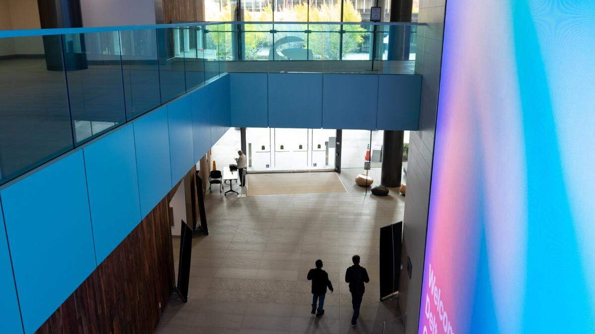 State workers walk inside of the new California Natural Resources Agency building at 715 P Street on Friday, Nov. 19, 2021, in Sacramento.