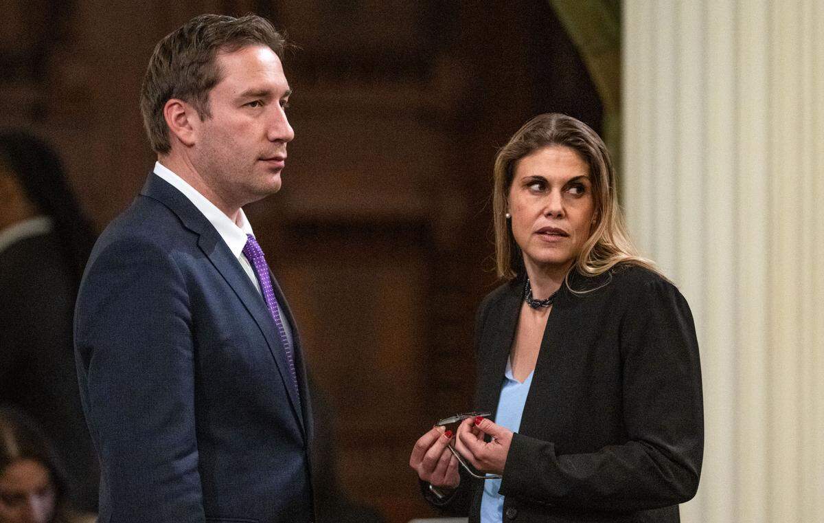 Assembly members Patrick Ahrens, D-Sunnyvale, and Maggy Krell, D-Sacramento, confer during a session at the state Capitol on Thursday.