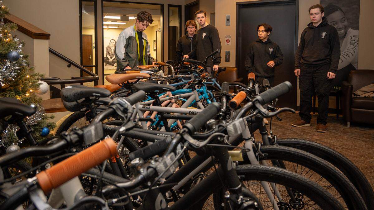 Winston Holtkamp, 17, left, Finn McGrath, 17, Owen Wilber, 17, Riley Domine, 17, and Rowan Diepenbrock, 19, right, of Boys 4 Bikes, deliver bikes to Stanford Youth Solutions on Dec. 19. The nonprofit raises money to buy bikes for underprivileged youth.