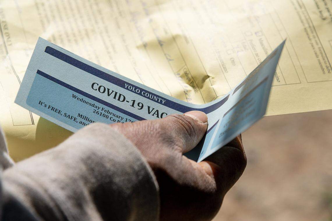 A farmworker holds his ticket for getting the COVID-19 vaccine on Wednesday, Feb. 17, 2021 at an organic farm near Esparto. Yolo County started clinics this week that work directly with the agricultural community to bring the vaccine to the workers without requiring appointments, forms or digital links.