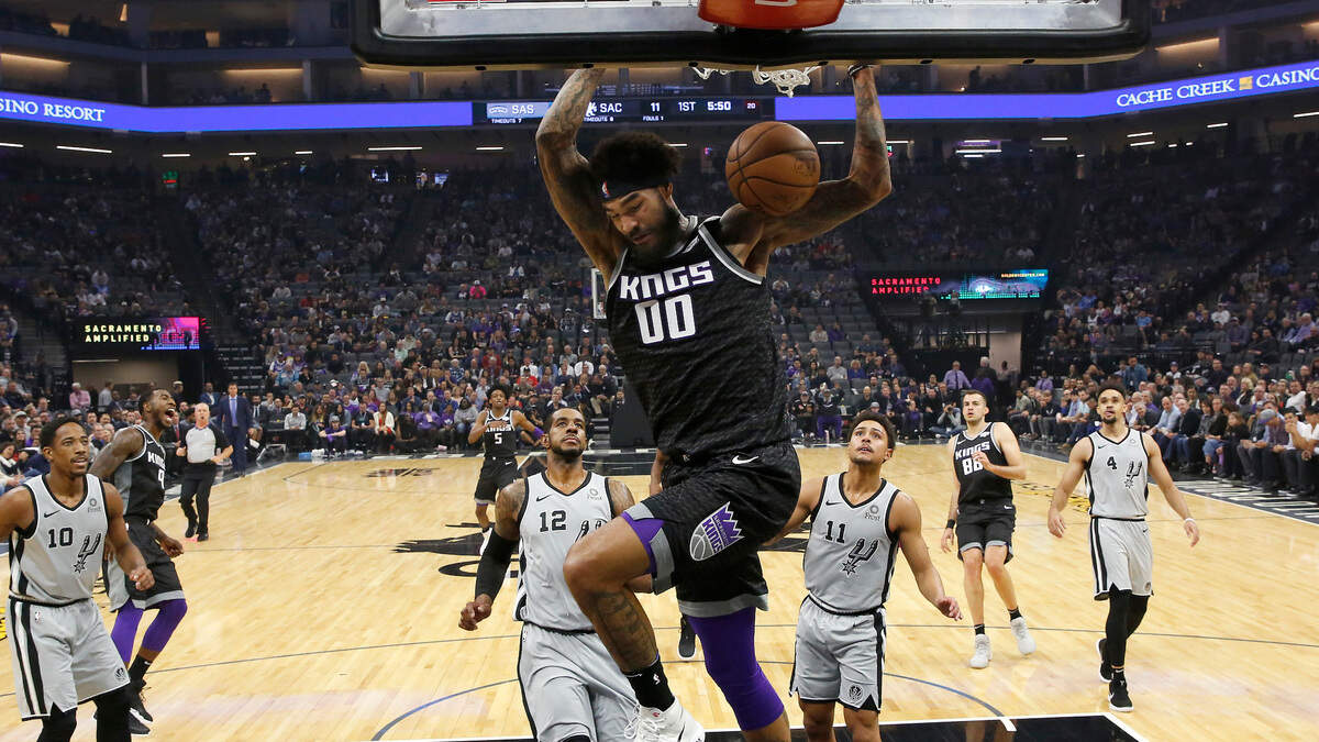 Kings center Willie Cauley-Stein (00) stuffs as the San Antonio Spurs’ LaMarcus Aldridge (12) and Bryn Forbes (11) look on in the first quarter of Monday night’s game at Golden 1 Center. Cauley-Stein had a double-double with 13 points and 13 rebounds as Sacramento defeated the Spurs 104-99.