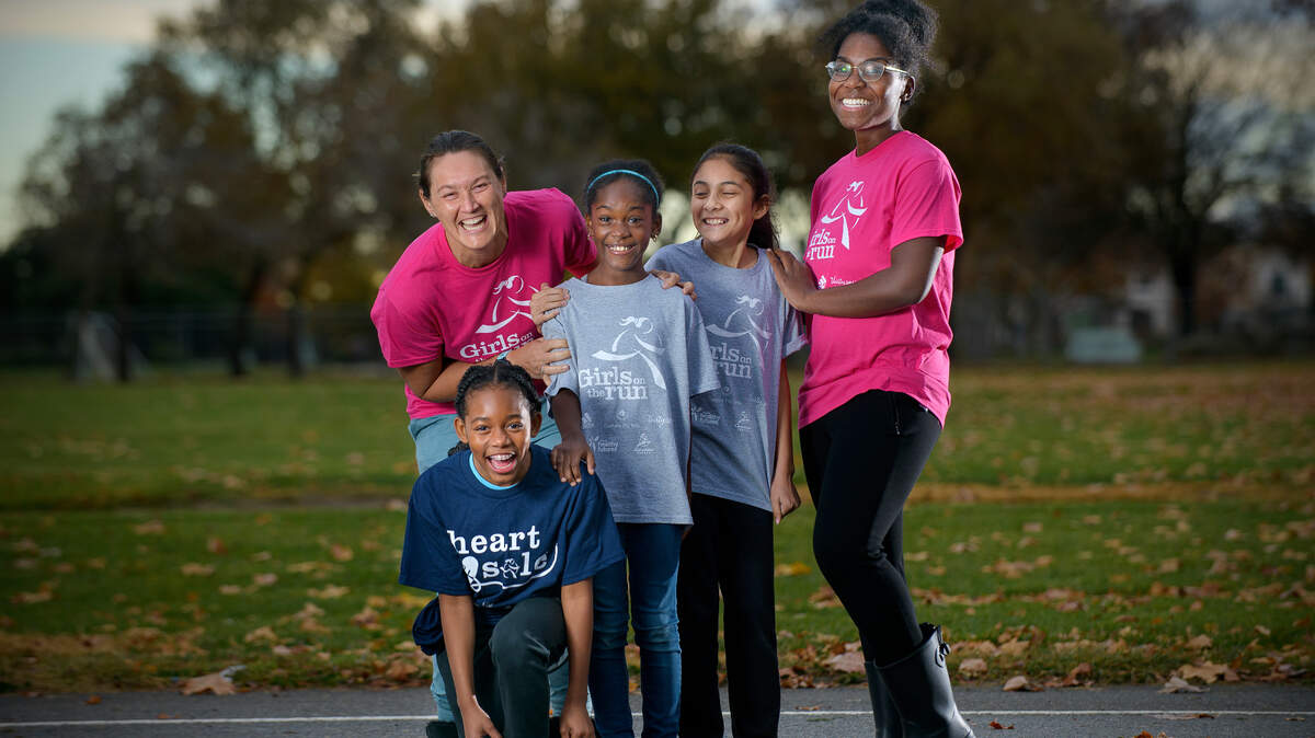 Candace Beam, left, and Trena Furlow, right, volunteer coaches with Girls on the Run of Greater Sacramento, stand with Charlea Hill, 11, left front, Honesty Williams, 9, and Alexa Zarate, 9, at Joseph Sims Elementary School in Elk Grove earlier this month.