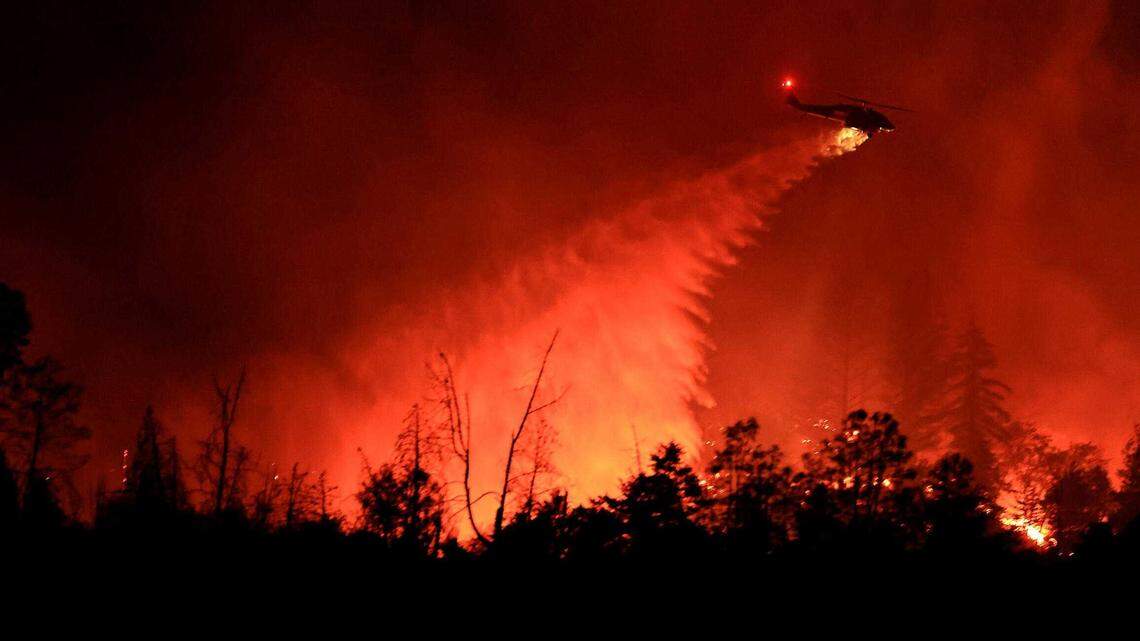 A Cal Fire Firehawk based out of the Hollister Air Attack base, is used to drop water Friday night on the advancing Pickett Fire. California can reduce wildfire risks under Senate Bill 326.