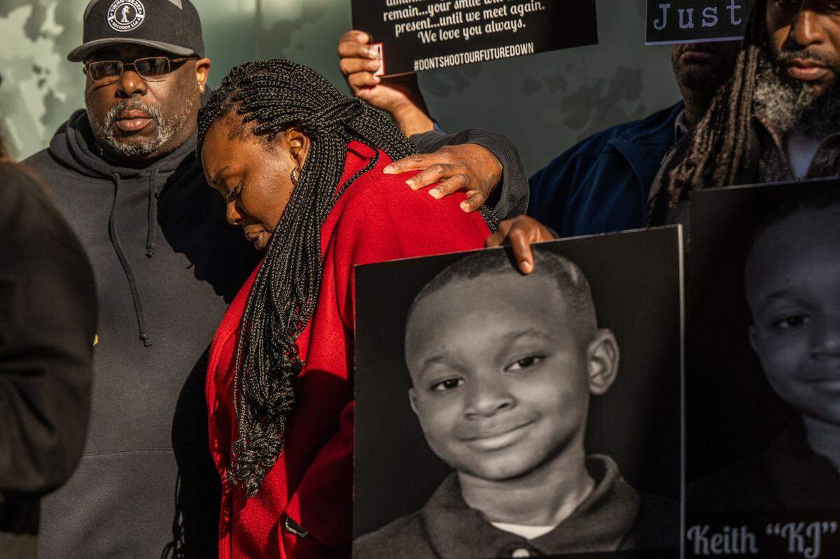 Willie Charles comforts his daughter Brittani Frierson, mother of Keith Jhay “KJ” Frierson, 10, on Friday, after a court appearance by Arkete Turan Davis, 53, the father of another 10-year-old who is suspected of shooting “KJ” with a stolen gun in Davis’ car.