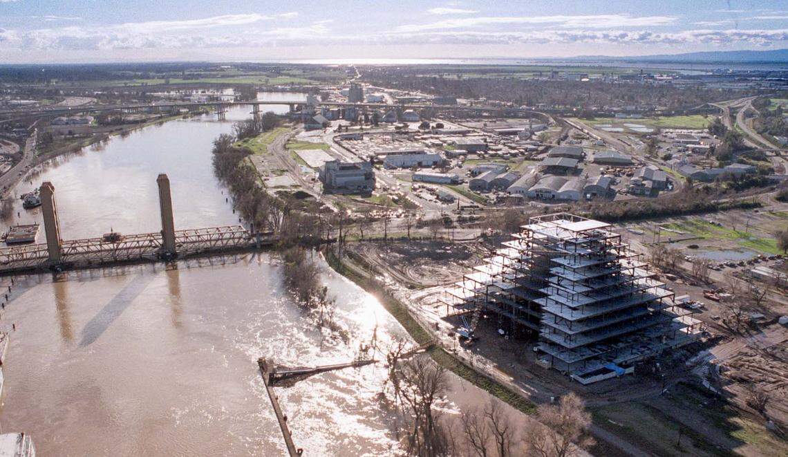 Warehouses stand on the future site of Sutter Heath Park in West Sacramento in January 1997, as the ziggurat building rises in the foreground.