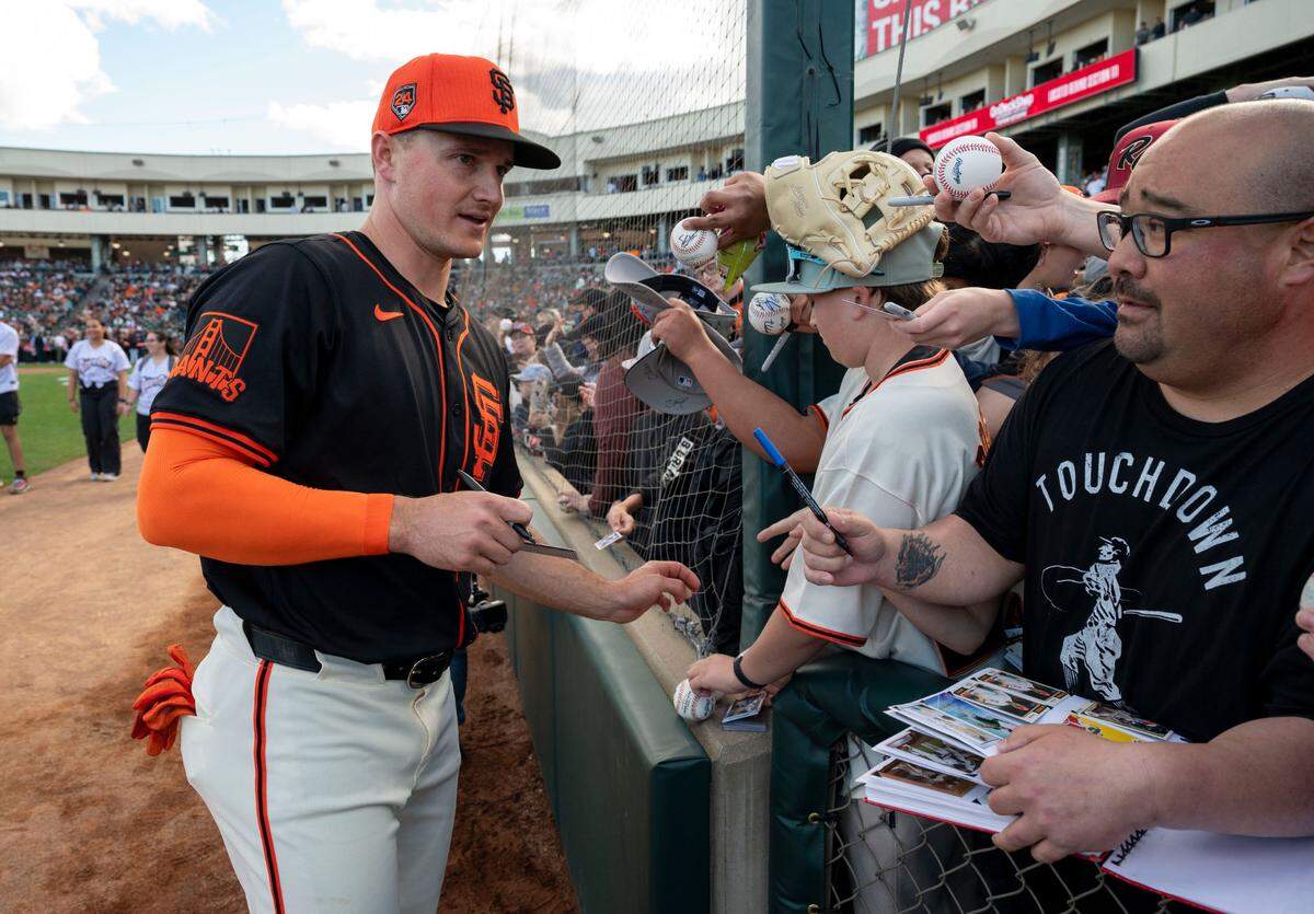 Matt Chapman of the San Francisco Giants signs autographs for fans prior to the game against the Sacramento River Cats on Sunday.