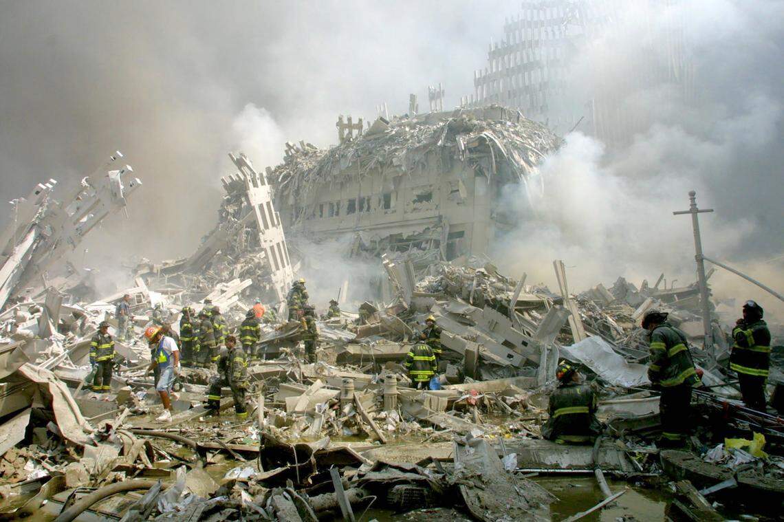 Firefighters make their way through the rubble after terrorists crashed two airliners into the World Trade Center in a deadly series of blows Tuesday that brought down the twin 110-story towers in New York Tuesday, Sept. 11, 2001.