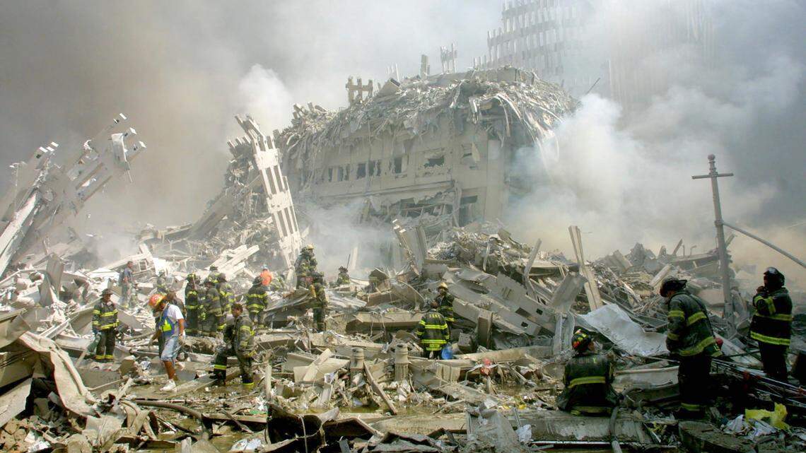 Firefighters make their way through the rubble after terrorists crashed two airliners into the World Trade Center in a deadly series of blows Tuesday that brought down the twin 110-story towers in New York Tuesday, Sept. 11, 2001.