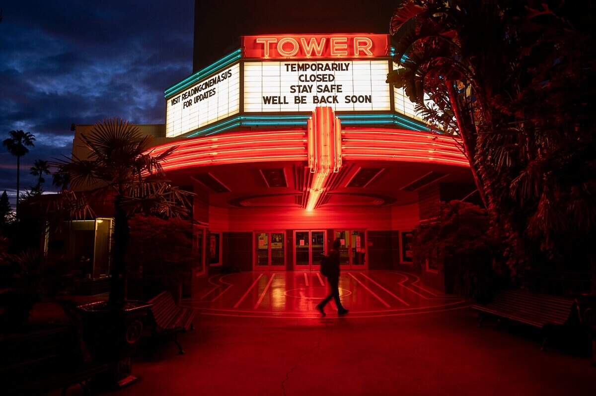 Kevin Slattery walks by the Tower Theatre on Broadway in Sacramento on Tuesday, March 24, 2020.