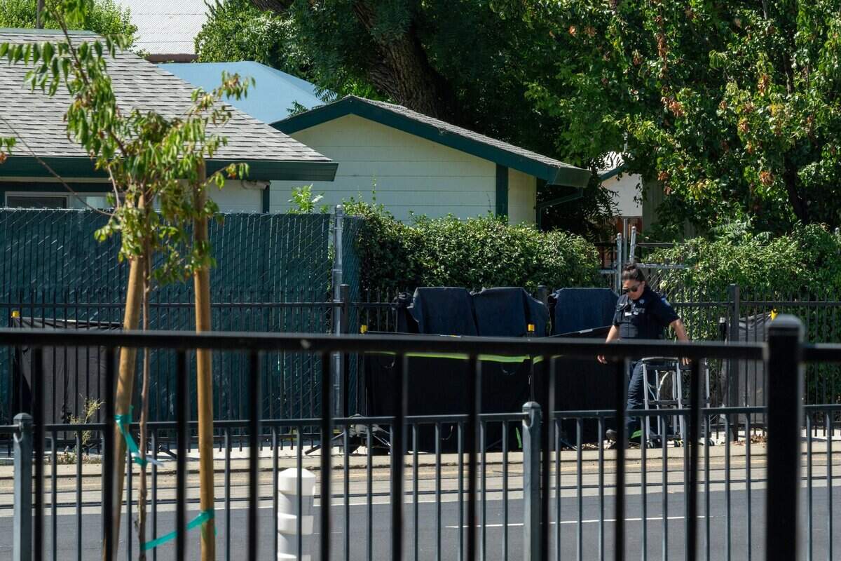 A Sacramento Police officer investigates the homicide of a homeless woman near homeless services provider Loaves & Fishes on Tuesday.