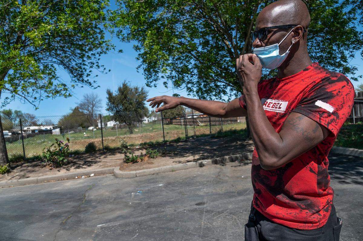 Billy Price Jr. stands in a parking lot behind Office Depot in south Sacramento on Monday after mourning the death of his friend Tammy Couisan, 46, at a memorial he made for her. He found her dead inside her tent in early March and said he has been visiting the memorial frequently. “She was a sweet lady would give you the shirt off her back,” Price said.