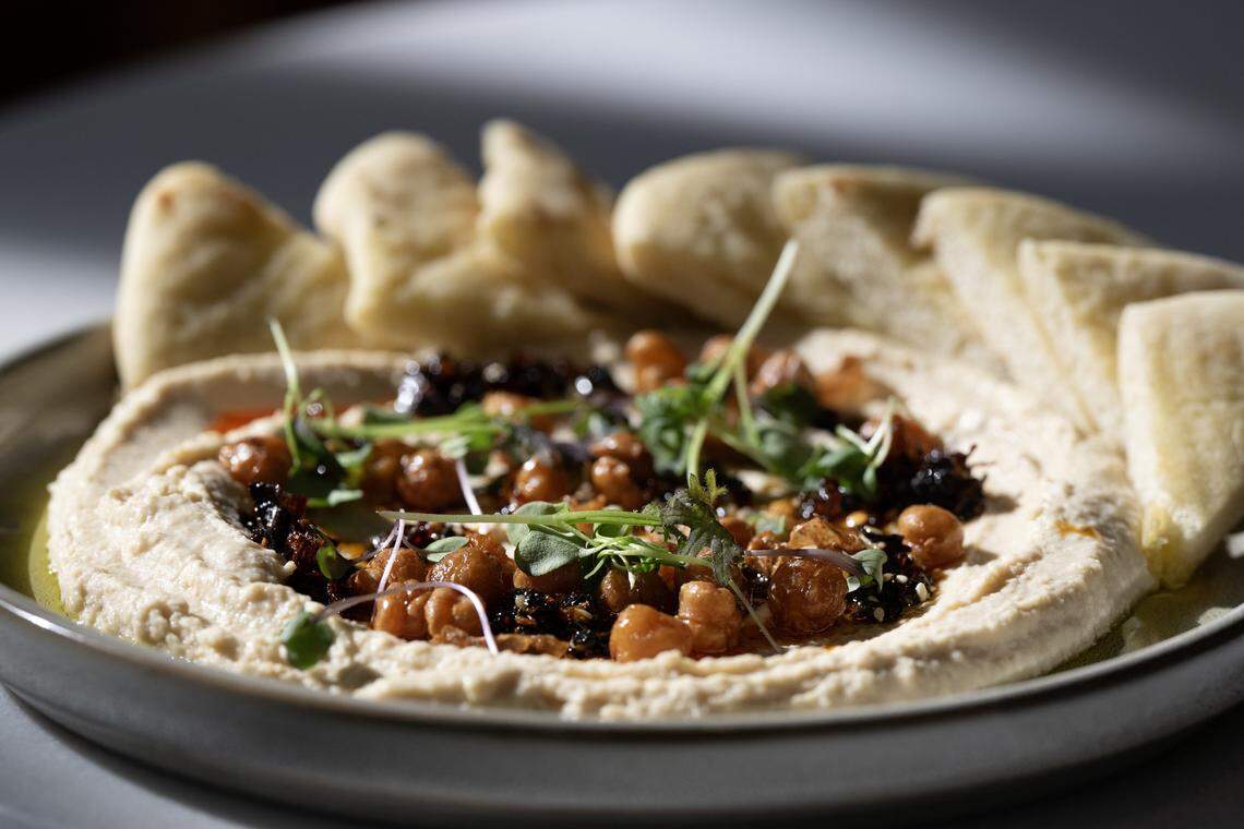Hummus, sesame chili crisp and scratch-made pita at Aiona in Sacramento on Thursday, April 16, 2026.