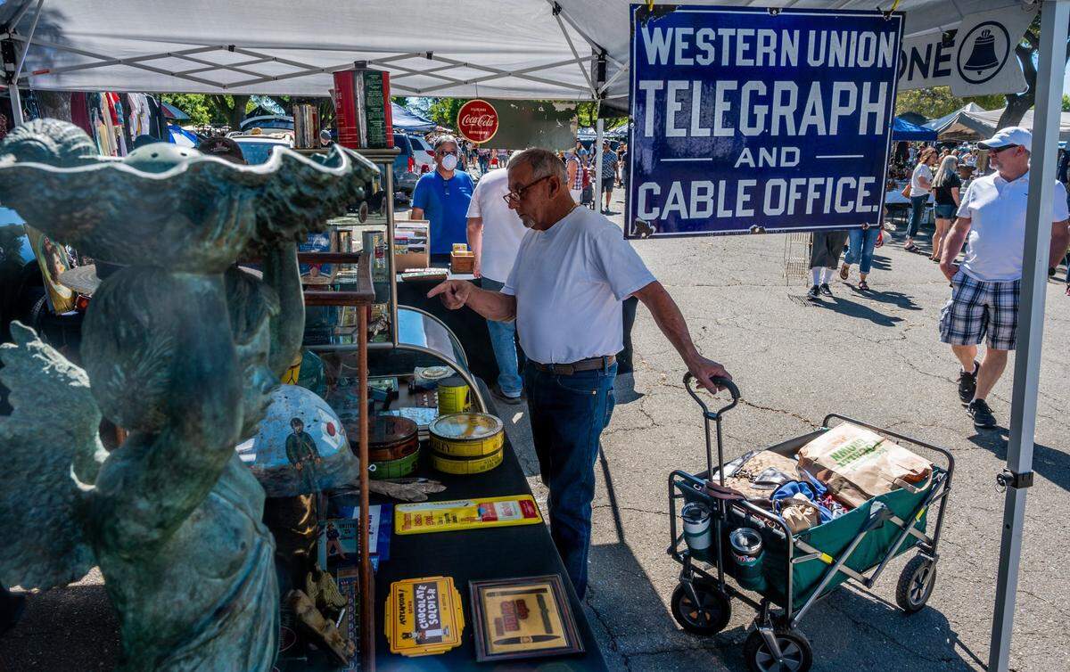 Rick Borjas, 68, of Orland, points at some merchandise at the Sacramento Antique Faire at the Sleep Train Arena in North Natomas on Sunday, June 13, 2021. The fair, typically held on the second Sunday of the month under the W-X freeway, was last held in March after it had to switch locations because of the Highway 50 construction project.