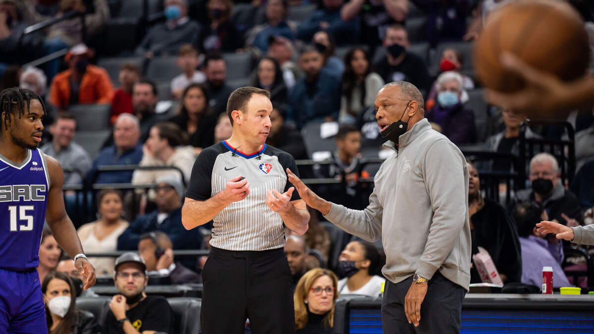 Sacramento Kings interim head coach Alvin Gentry, right, contests a call with referee Josh Tiven (58) during the fourth period against the Oklahoma City Thunder at the NBA basketball game Saturday, Feb. 5, 2022, at Golden 1 Center in Sacramento. The Kings beat the Thunder 113-103.