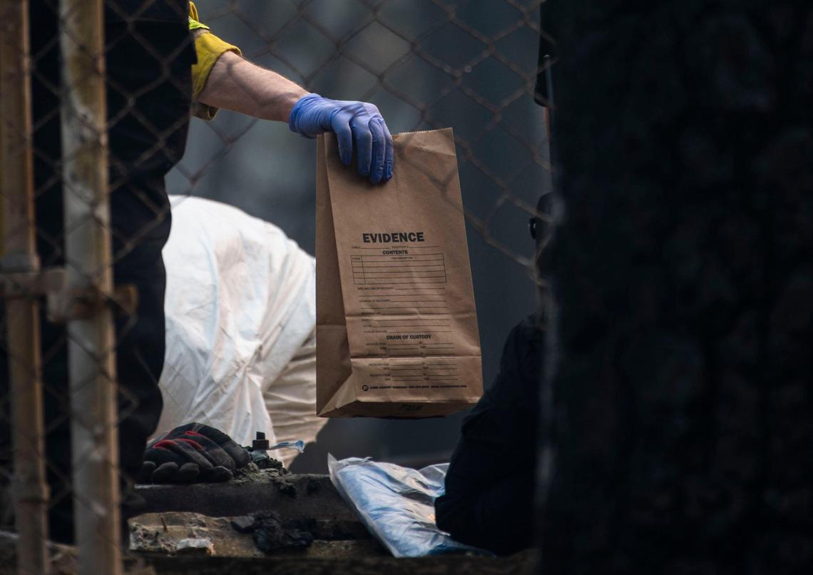 A search and rescue team from Cal Fire and El Dorado County hand off an evidence bag in Magalia on Thursday, Nov. 15, 2018. The Camp Fire burned many of the homes in the area.