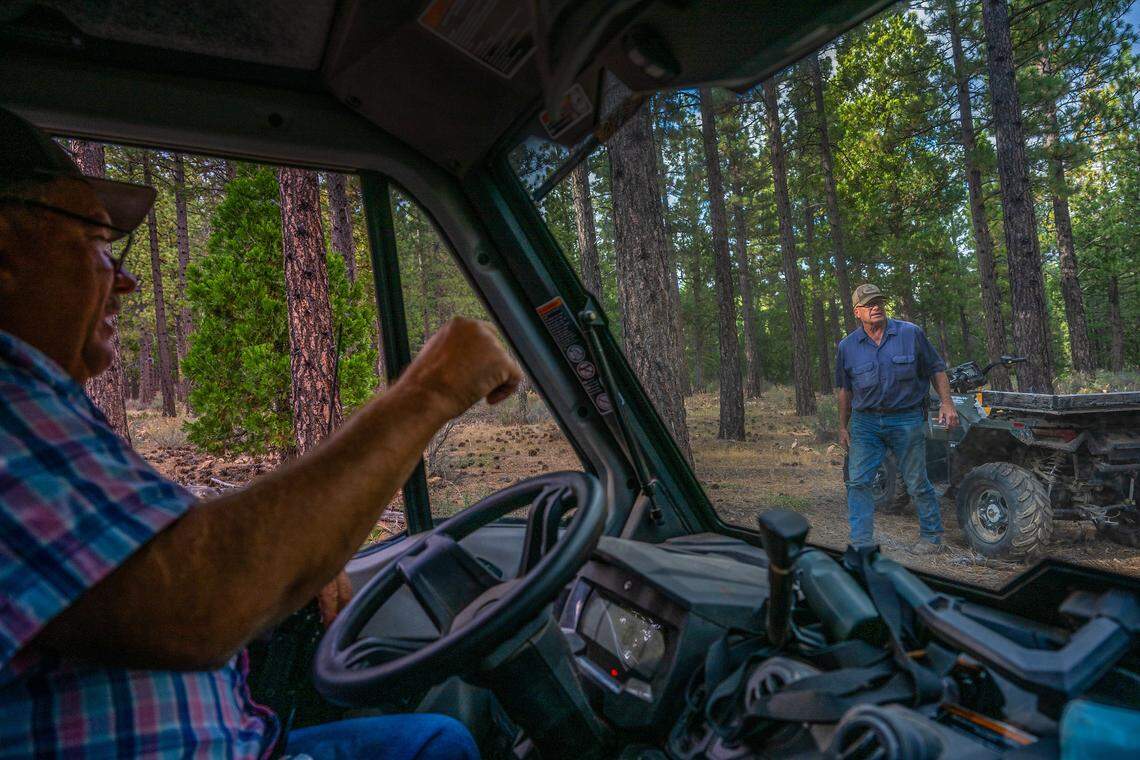 Sierra County Supervisor Paul Roen, left, and Plumas County Supervisor Dwight Ceresola patrol an area behind Roen’s home on Friday  near the Sierra-Plumas county line, where a wolf was sighted 45 minutes earlier. The supervisors, who have both lost livestock to gray wolves, say they are up day and night patrolling and working to help prevent further attacks on their livestock.