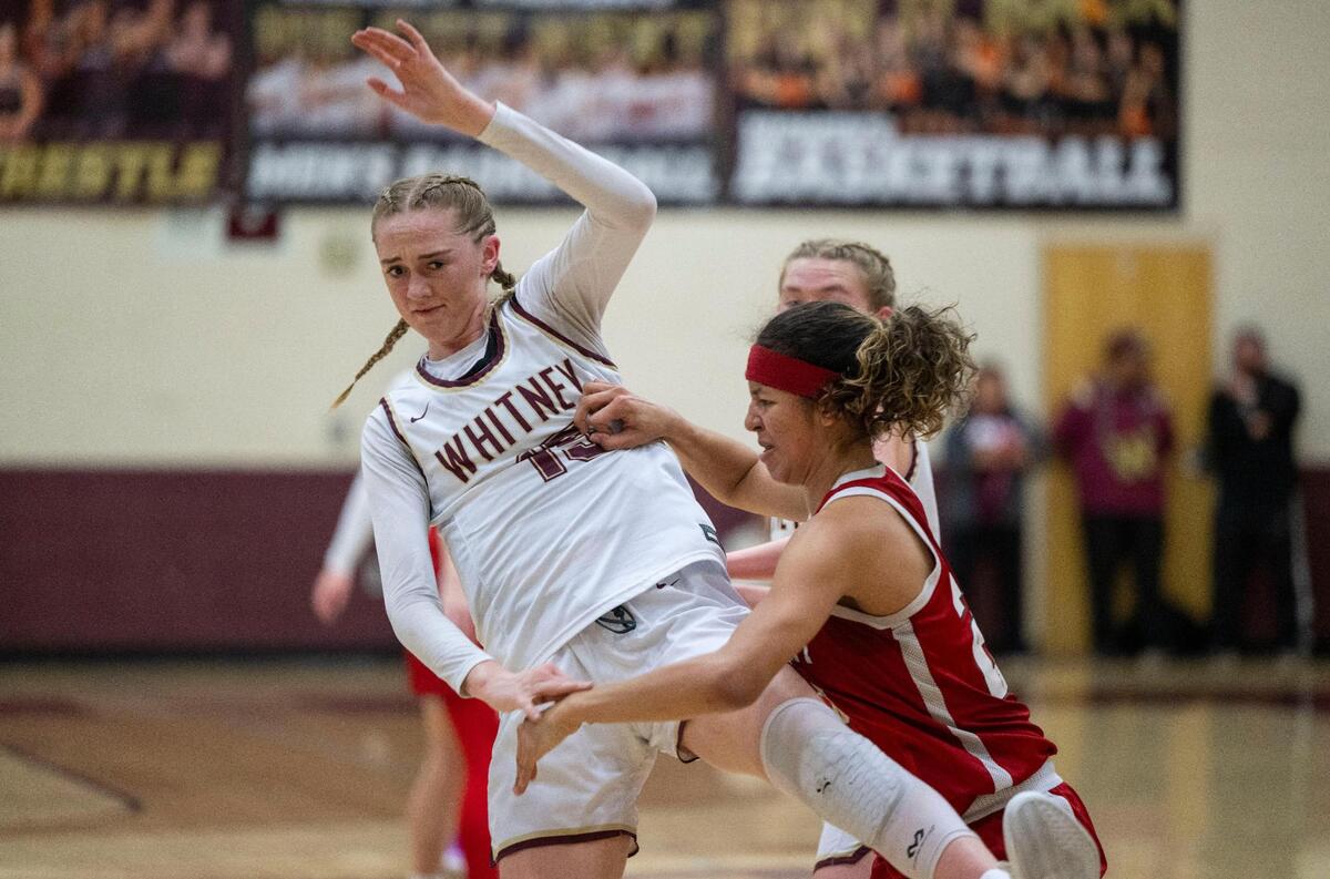 The Whitney Wildcats’ Harper Peterson and the McClatchy Lions’ Nina Cain show their claws while guarding each other during a CIF Northern California regional girls basketball championship quarterfinal on Thursday at Whitney High School. Cain was called for a personal foul.