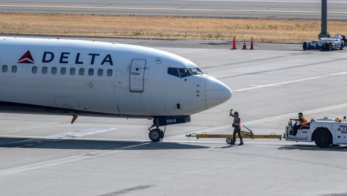 A ground crew prepares a Delta Airlines plane for flight at Sacramento International Airport in July 2024.