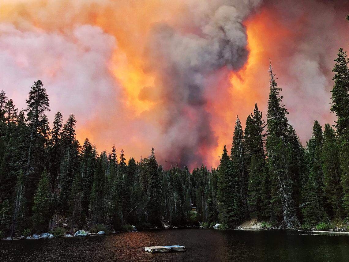 Smoke from the Creek Fire billows beyond a ridge as seen from Huntington Lake on Sept. 5 at Huntington Lake.