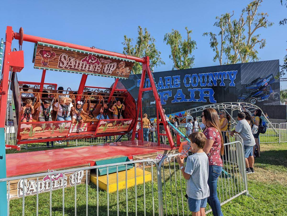 Fairgoers check out the rides at opening day of the Tulare County Fair earlier this month.