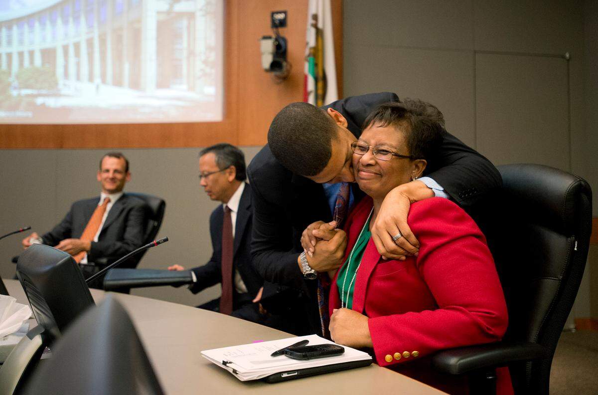 Then-Sacramento Mayor Kevin Johnson gives Councilwoman Bonnie Pannell a kiss after her vote in support of the arena financing plan in 2013. Council members Kevin McCarty, far left, and Darrell Fong voted against the plan. The council passed a wide-ranging deal to finance a entertainment and sports center and keep the city’s NBA team from moving to Seattle.