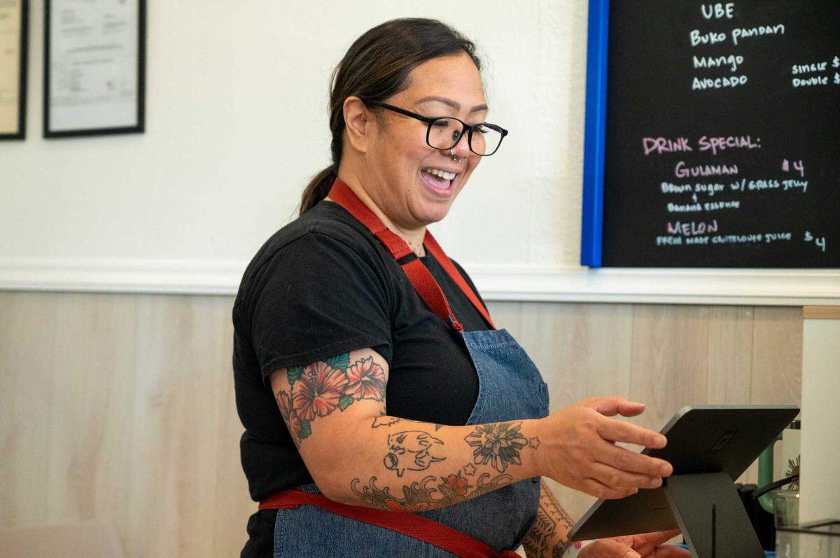 Co-owner Joanne Suavillo inputs orders at Spoon and Fork in Sacramento on Thursday.