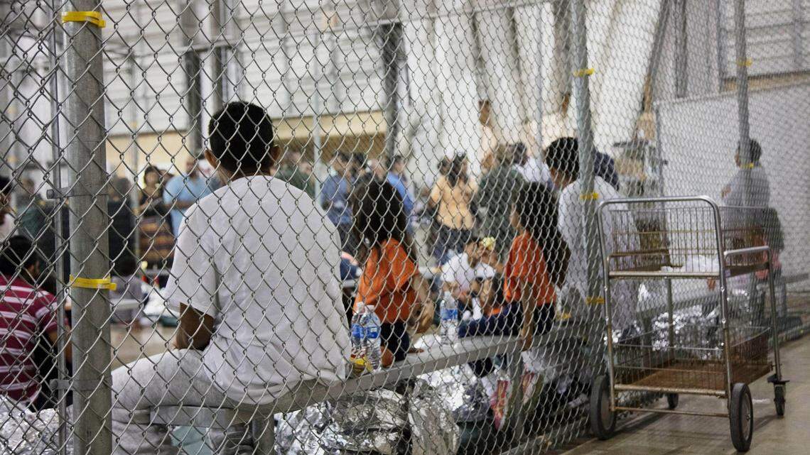 In this photo provided by U.S. Customs and Border Protection, people who've been taken into custody related to cases of illegal entry into the United States, sit in one of the cages at a facility in McAllen, Texas, Sunday, June 17, 2018.