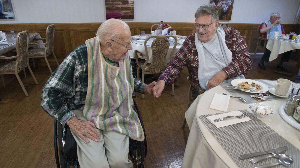 Bishop Francis Quinn greets fellow resident, Montie Brasseur, during breakfast in the dining room at Mercy McMahon Terrace on Friday, March 16, 2018 in Sacramento. Quinn, who served as Bishop of the Sacramento Diocese from 1980-92, has lived at the retirement home for nearly 10 years.