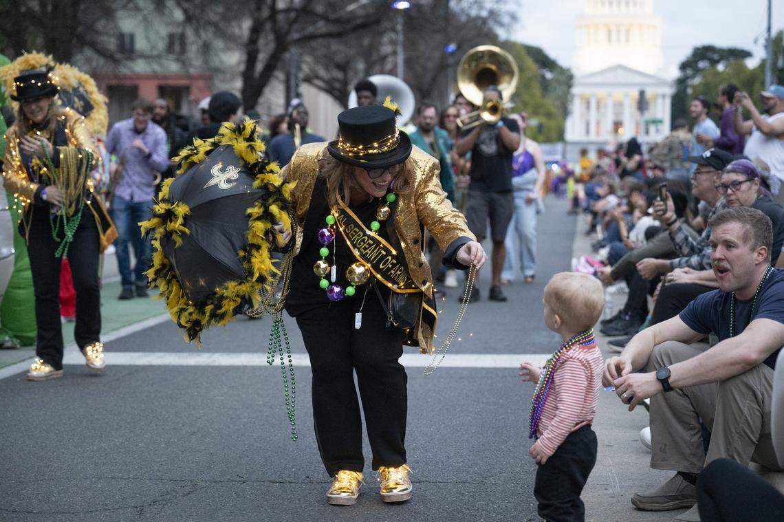 The NOLACal Second Liners pass out beads during the City of Trees Parade in Sacramento on Saturday, Feb. 28, 2026.