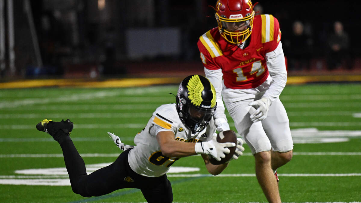 The Del Oro Golden Eagles' Chase Carmazzi (80) intercepts a pass intended for The Jesuit Marauders' Stevie Hughes (14) late In the second half on Friday, Oct. 17, 2025, in Carmichael.
