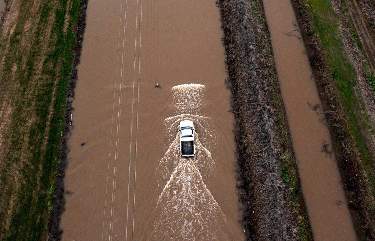 A truck is driven on flooded waters on Lambert Rd. in Point Pleasant on Monday.
