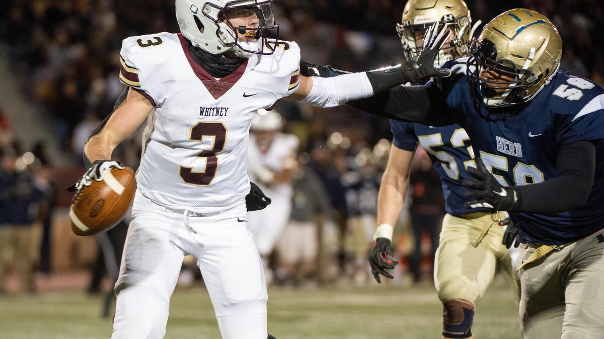 Whitney quarterback Eli Brickhandler tries to fend off Elk Grove’s Kylan Fontes in the second quarter of the high school football section championship game Friday, Nov. 29, 2019, at Sacramento City College’s Hughes Stadium. Elk Grove beat Whitney 35-0 in the Sac Joaquin Section D2 championship.