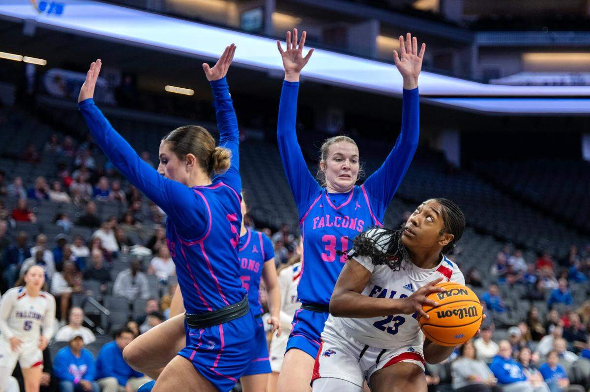 The Christian Brothers Falcons’ Journey Williams (23) looks to shoot as he Atwater Falcons’ Cami Gibson (31) defends in the second half of the CIF Sac-Joaquin Section Division ll girls basketball championship game at Golden 1 Center on Thursday.