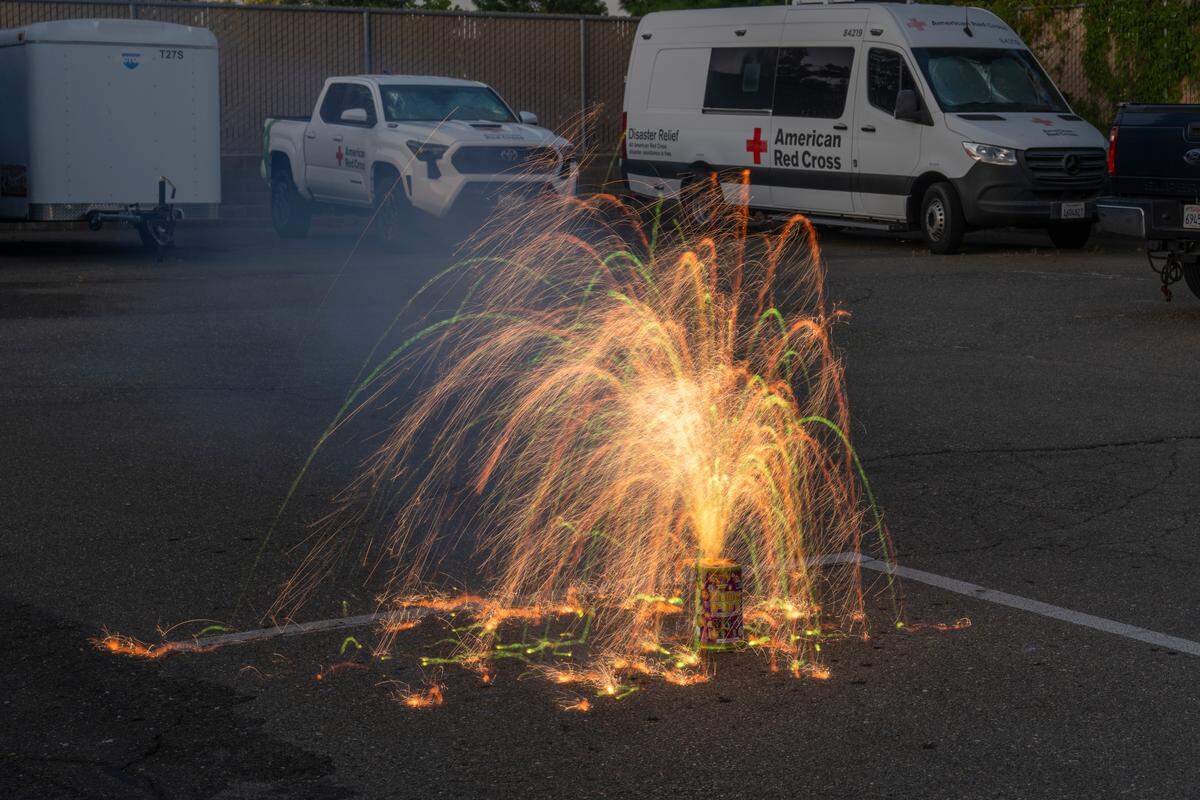 Phantom Fireworks’ Flower Pot Fountain shoots sparks in the air in the parking lot of Sacramento Fire Department Station 19 on Thursday, June 19. The product is quieter than most fireworks.