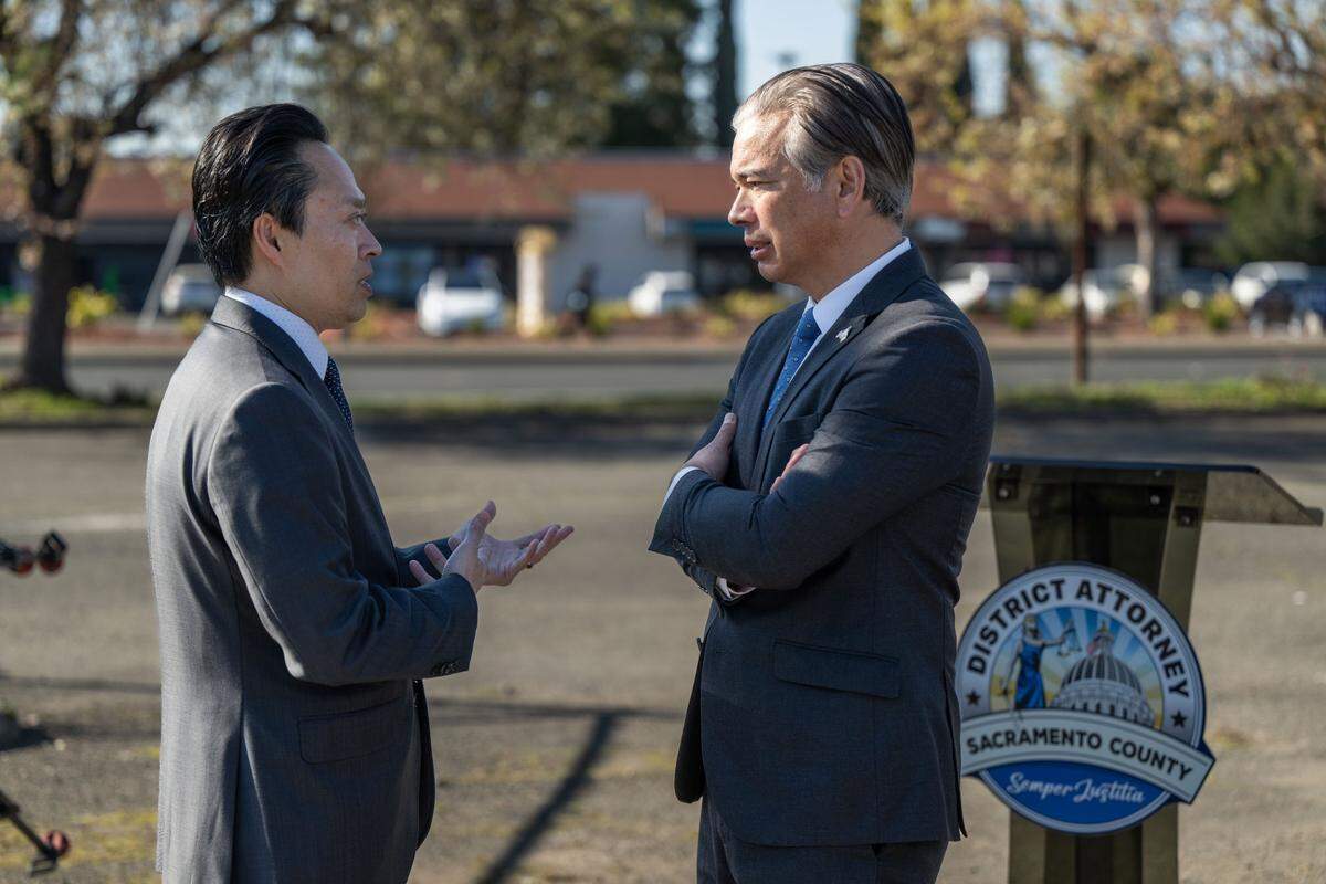 Sacramento District Attorney Thien Ho talks with California Attorney General Rob Bonta after they held a press conference in Sacramento to announce the establishment of the Sacramento Regional Human Trafficking Task Force on Tuesday. Ho said that the location in south Sacramento was selected because a woman was trafficked in the shopping center in the distance.