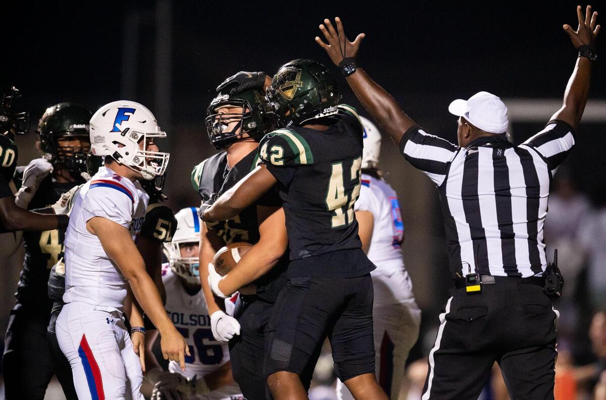Monterey Trail’s Tayshaun Evans is congratulated by teammate Tanaki Tonga, right, after recovering a loose ball from Folsom quarterback Tyler Tremaine, left, in the end zone for a touchdown in the second quarter at the nonleague high school football game Friday, Aug. 20, 2021, at Monterey Trail High School in Elk Grove.