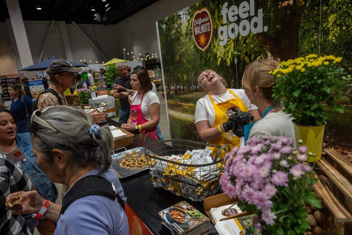 Vanessa Rock of the California Walnut Commission laughs while handing out “Chorizo Crumble” made from walnuts and black beans at the Terra Madre Americas festival on Friday at the SAFE Credit Union Convention Center in Sacramento.