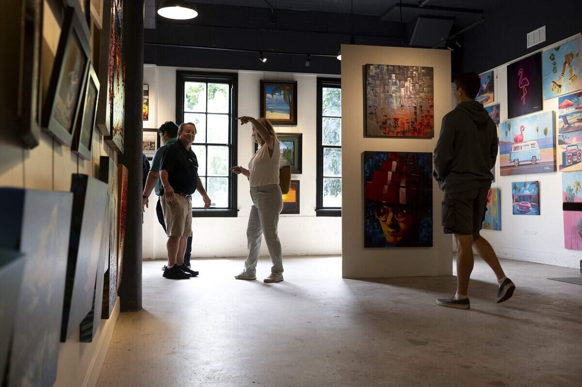 Visitors browse the Panoply Fine Art gallery in The Paperworks in Old Sacramento on Friday, June 26, 2026.