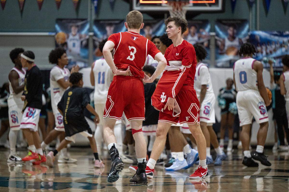 The Folsom Bulldogs’ Jack Shull (4) and Scott Nardinelli (3) leave the floor after the 72-65 loss to the Sheldon Huskies in a CIF Sac-Joaquin Section Division I semifinal game Tuesday in Vineyard.