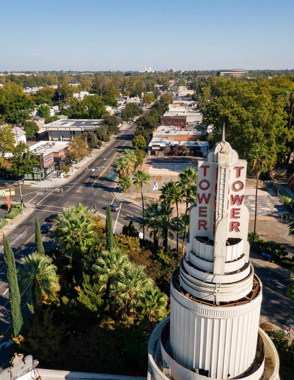 The landmark Tower Theatre sign at Broadway and Land Park Drive is seen in a drone photo looking east over a relatively quiet Broadway on Saturday afternoon, Oct. 6, 2022, in Sacramento.