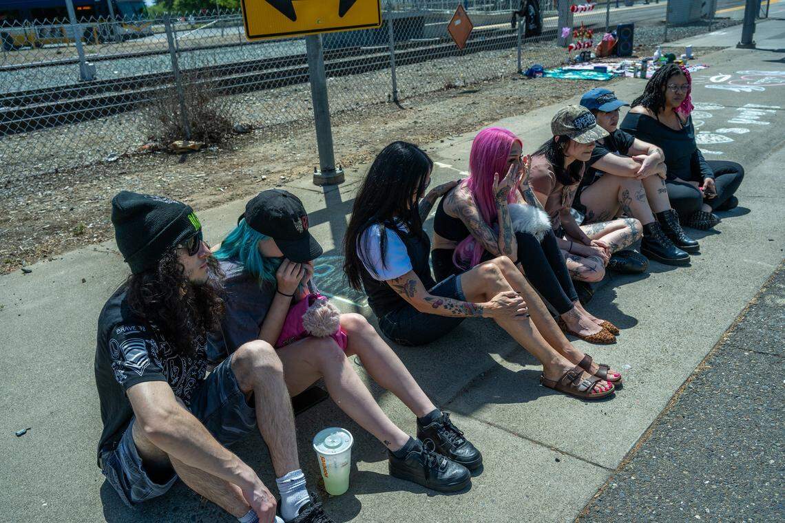 Erika Pringle wipes away tears in April after hearing an emergency vehicle siren near the spot where her brother, Andrew Pringle, was struck and killed by a car two years earlier, as she gathers with friends for a memorial near the intersection of Folsom Boulevard and Manlove Road in Rosemont.