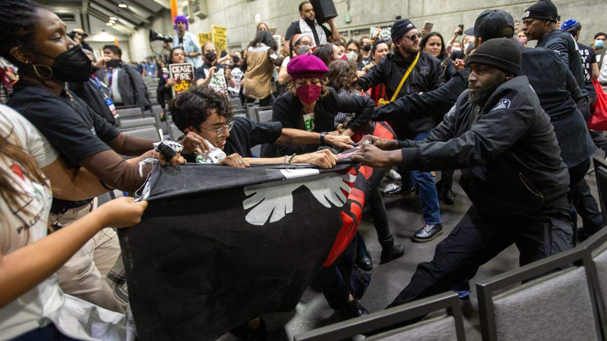 Demonstrators wrestle with security guards over a banner calling for a cease-fire in the Israel-Hamas war during a protest at the Democratic nominating convention at the SAFE Credit Union Convention Center in Sacramento on Nov. 18, 2023. The photo received a first-place award in the annual California News Publishers Association journalism awards.